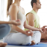 people meditating together in a yoga class