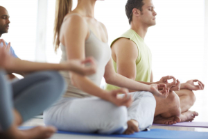 people meditating together in a yoga class