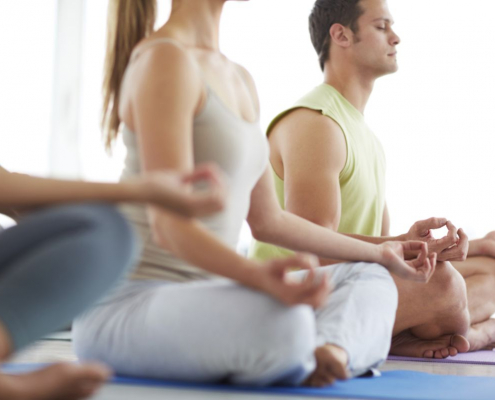 people meditating together in a yoga class