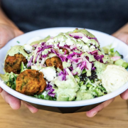 person holding a falafel salad