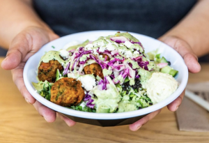 person holding a falafel salad