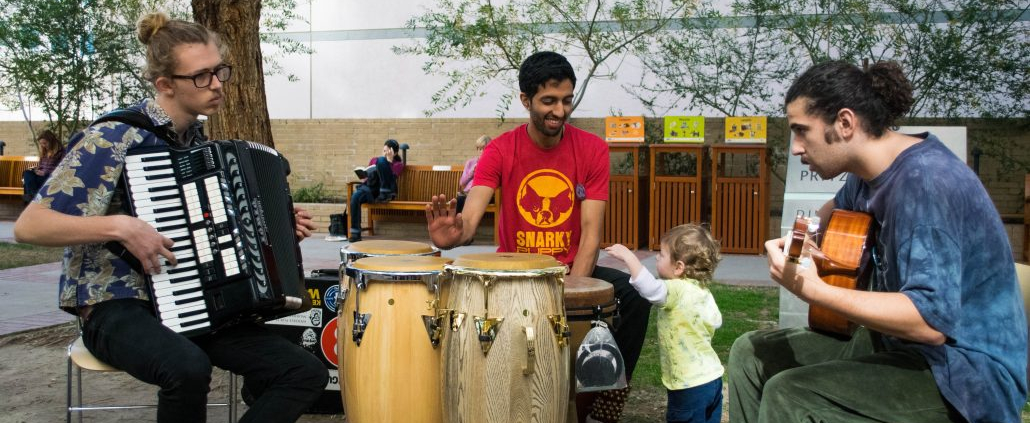 3 guys playing music outside