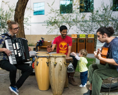 3 guys playing music outside