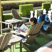 A man and a woman sitting on chairs relaxing outside