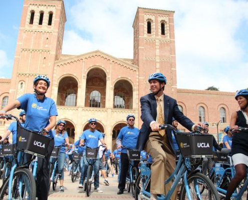 A group of people biking on campus using the ucla bikes