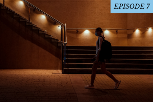 woman walking alone in the dark with a mask on