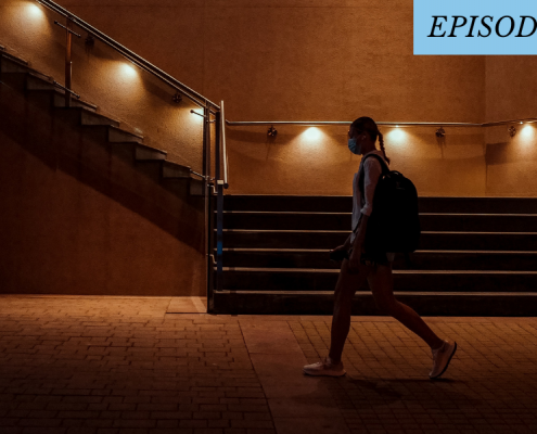 woman walking alone in the dark with a mask on