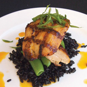 Fish on top of some black rice