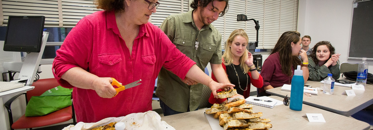 Evan Kleiman's students take a break from serious discussions about food issues to enjoy a focaccia pizza she made. Sharing food and recipes is an essential part of the course.