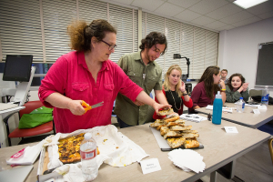 Evan Kleiman's students take a break from serious discussions about food issues to enjoy a focaccia pizza she made. Sharing food and recipes is an essential part of the course.