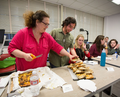 Evan Kleiman's students take a break from serious discussions about food issues to enjoy a focaccia pizza she made. Sharing food and recipes is an essential part of the course.