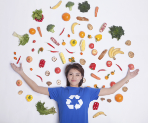 a woman with veggies surrounding her in a picture