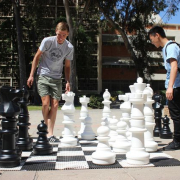 2 students playing chess outside