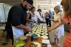 Chef serving food to some customers at an event