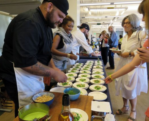 Chef serving food to some customers at an event