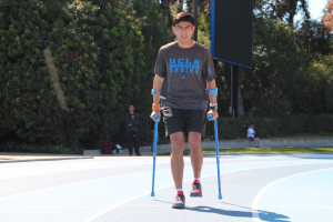 Person with crutches walking around Drake Stadium