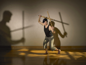 A woman dancing with sticks