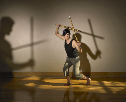 A woman dancing with sticks