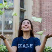 A girl throwing some pieces of cabbage in the air