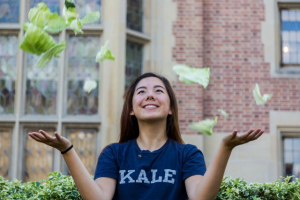 A girl throwing some pieces of cabbage in the air