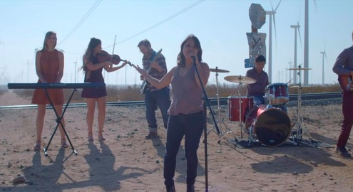 students performing in the middle of no where in the desert