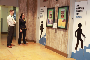 A man and a woman standing in front of the elevators