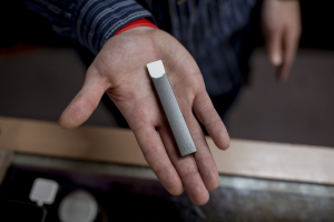 Person holding a Juul Vape