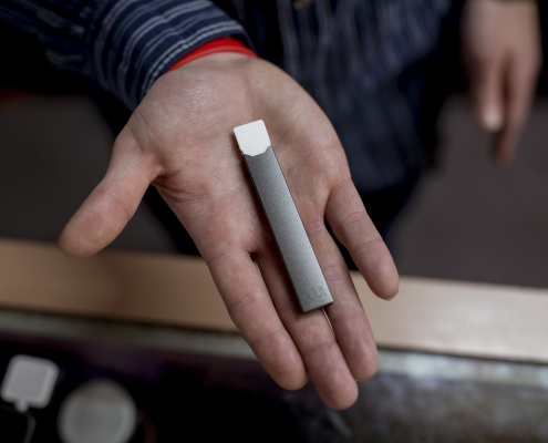 Person holding a Juul Vape