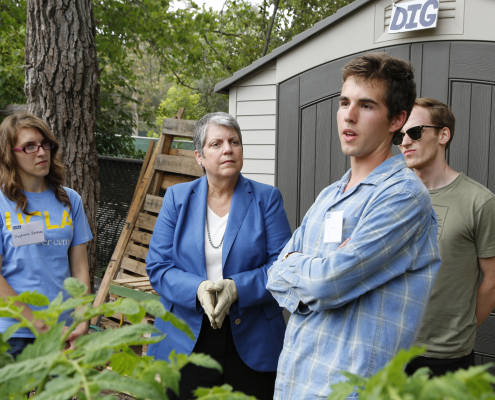 Janet Napolitano with some students in the garden